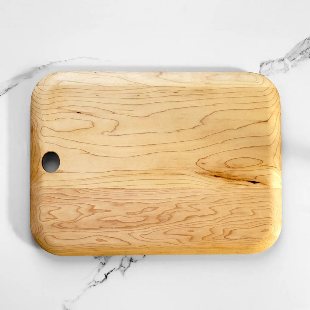 Wooden cutting board on a marble surface