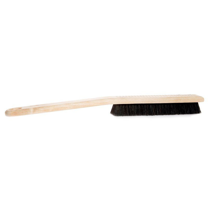 Cleaning brush with wooden handle and black bristles on a white background