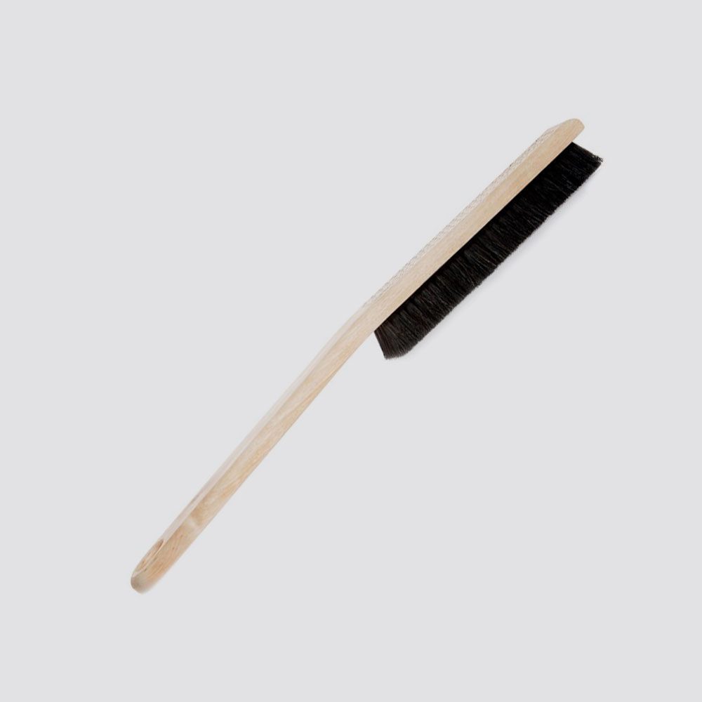 Duster with black bristles on a light gray background