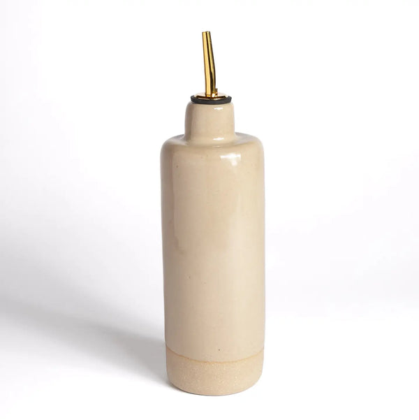 Beige ceramic bottle with gold cap on a white background