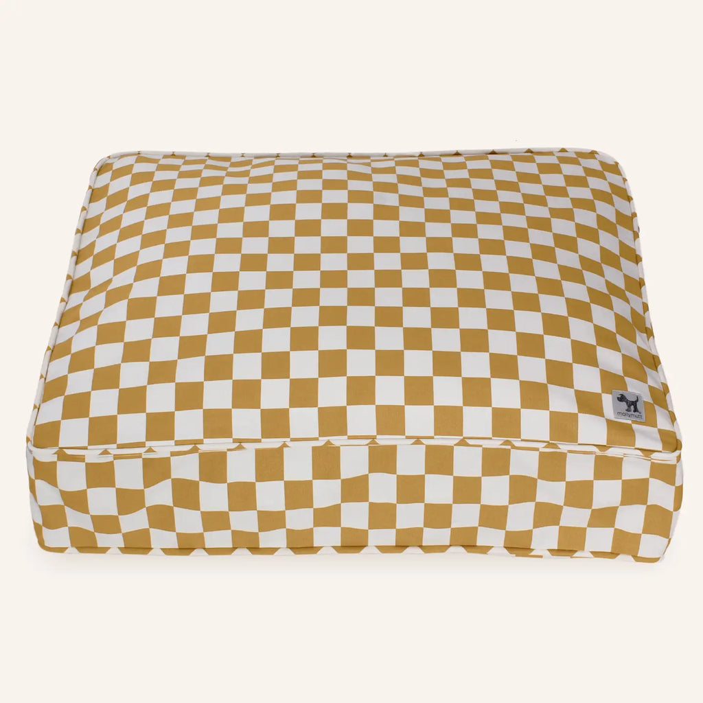 Checkered pet bed with mustard and white pattern on a white background