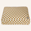 Checkered pet bed with mustard and white pattern on a white background