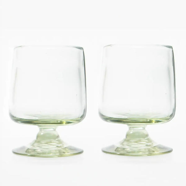 Two clear glass tumblers on a white background