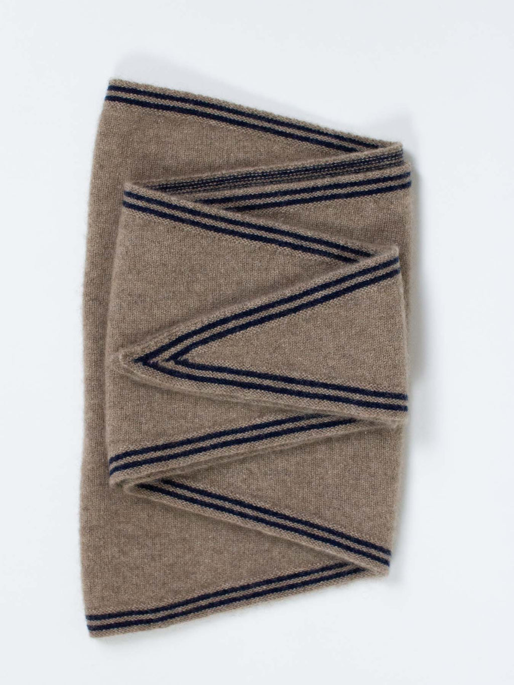 A folded camel-colored knit scarf with navy blue stripes, displayed on a clean white background.