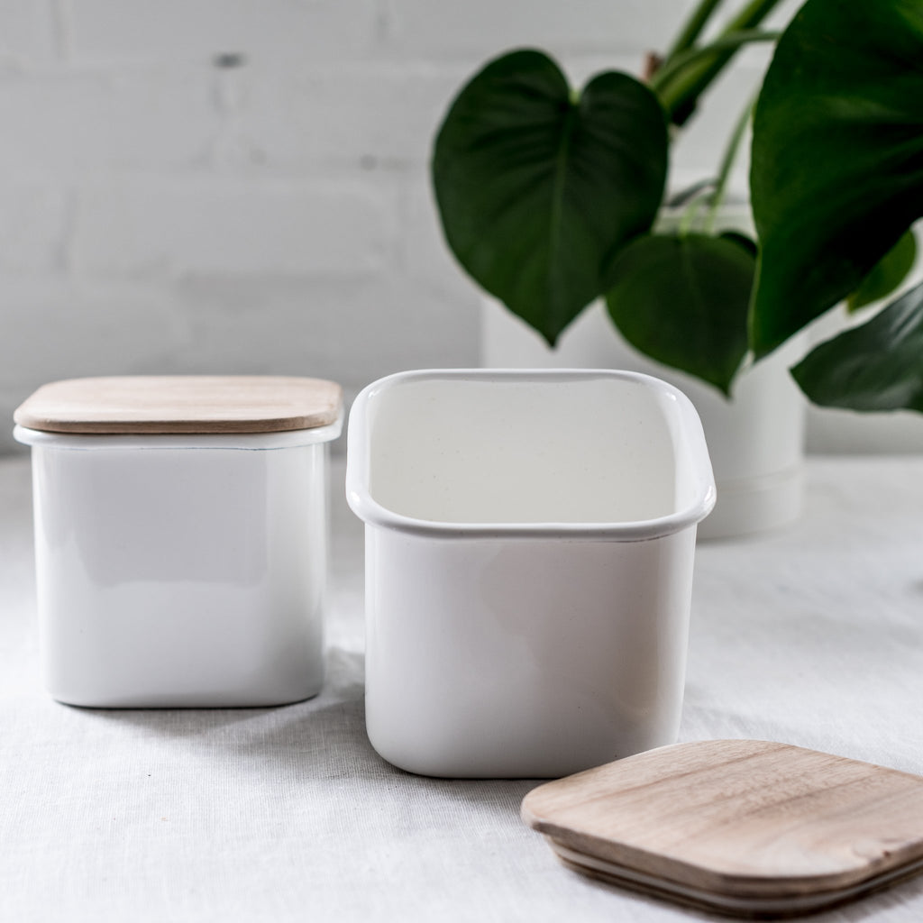 two enamel storage containers with acacia wood lids